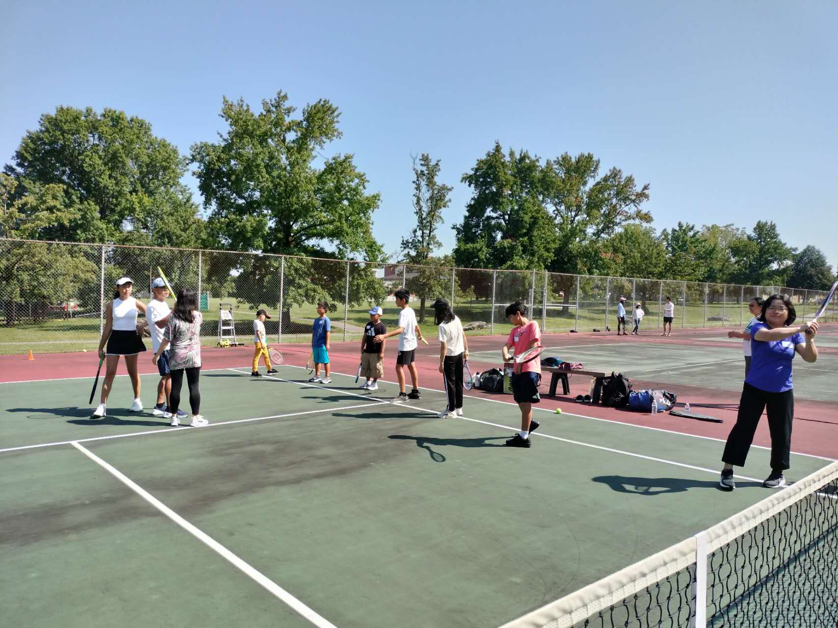 Parents and children playing tennis together