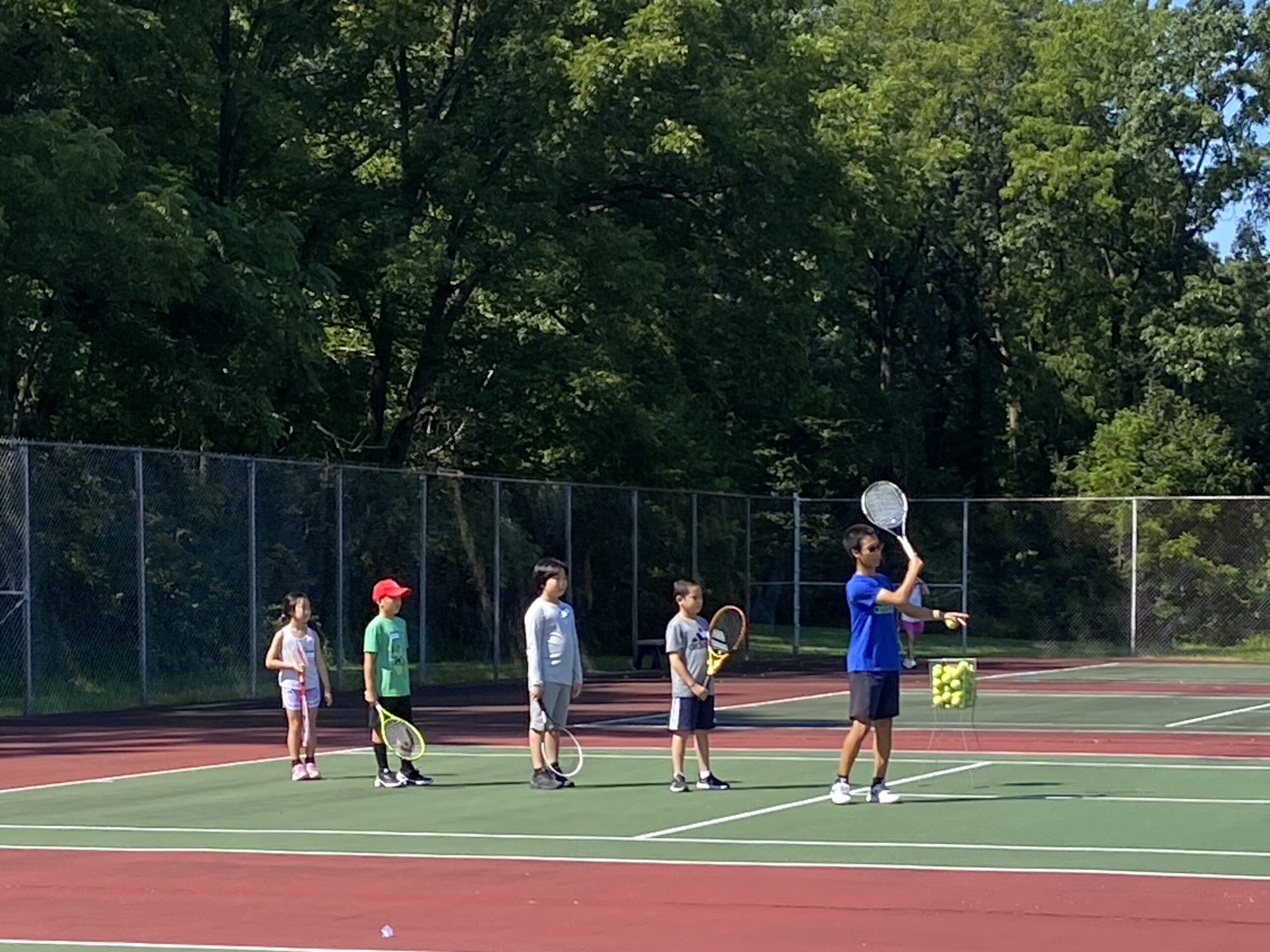 Players receiving coaching during the 2023 fall tennis club