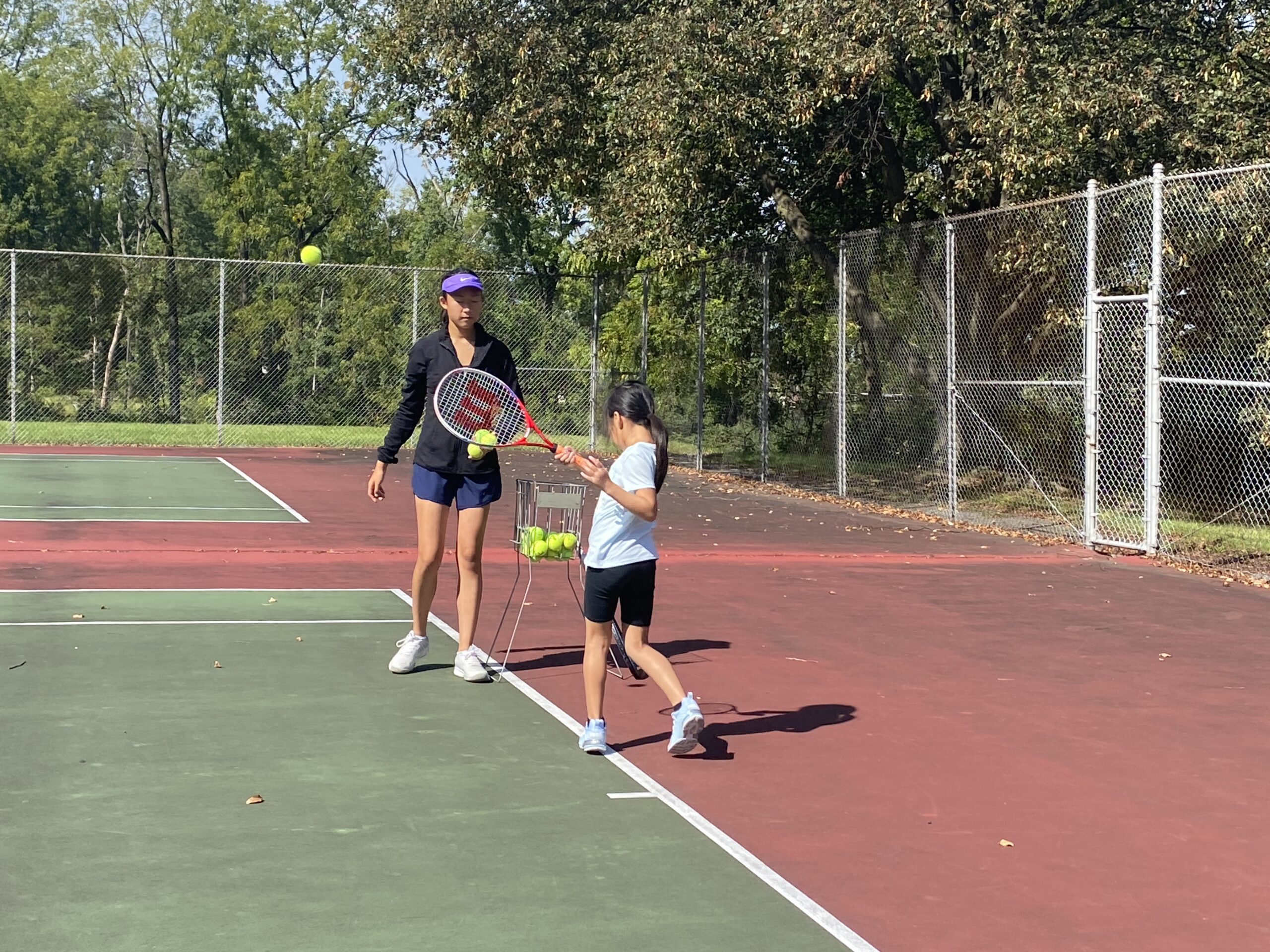 Fall club participants practicing across the tennis courts
