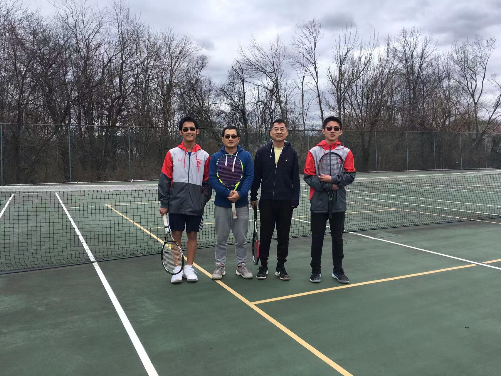 Four spring tournament players standing together on the court