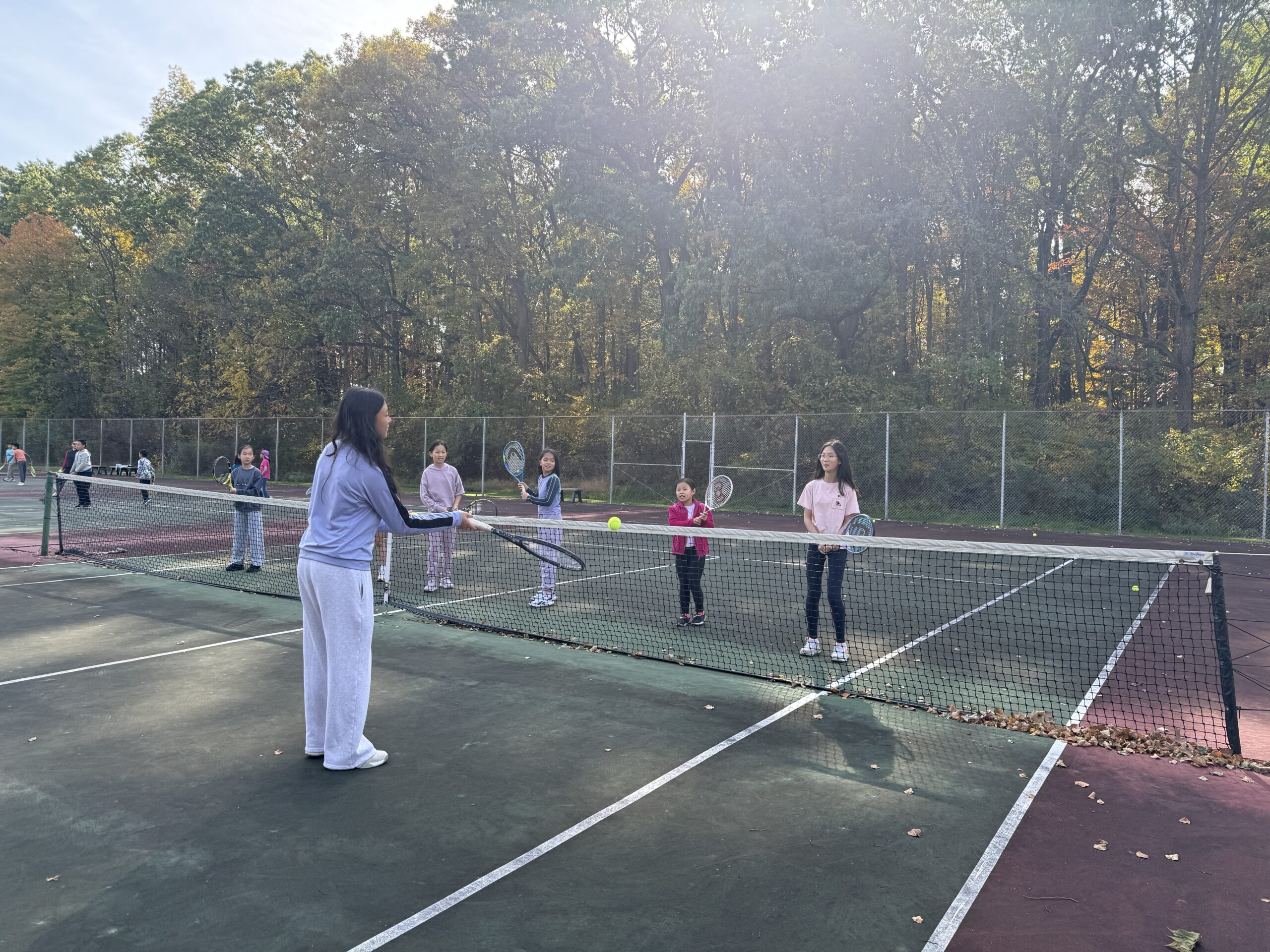 Families enjoying fall tennis