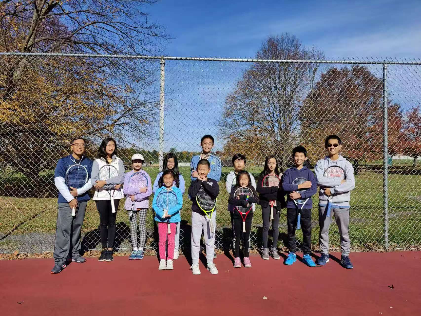2022 fall tennis club players, families, and coaches standing together