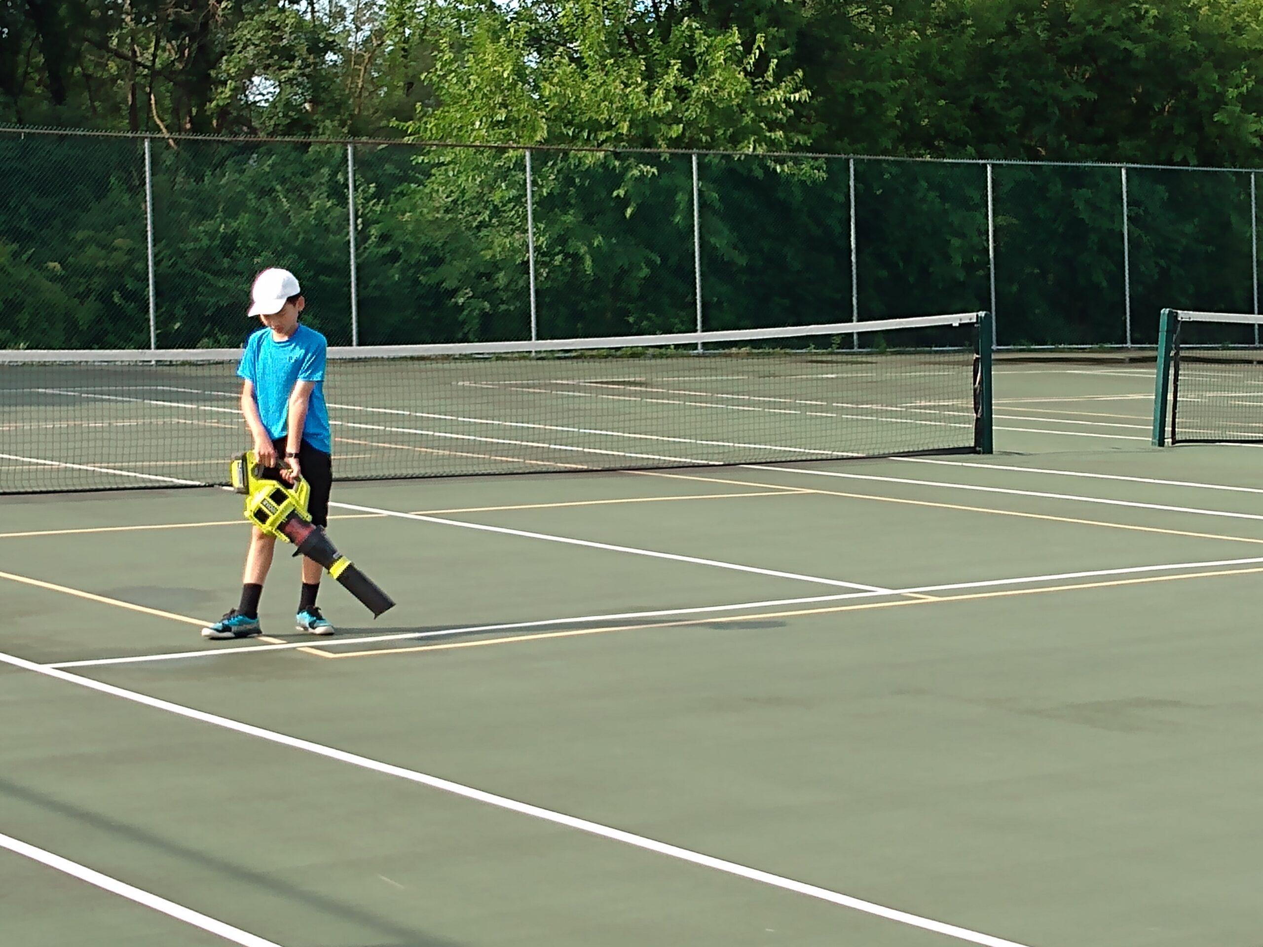 The summer camp coaches preparing the court