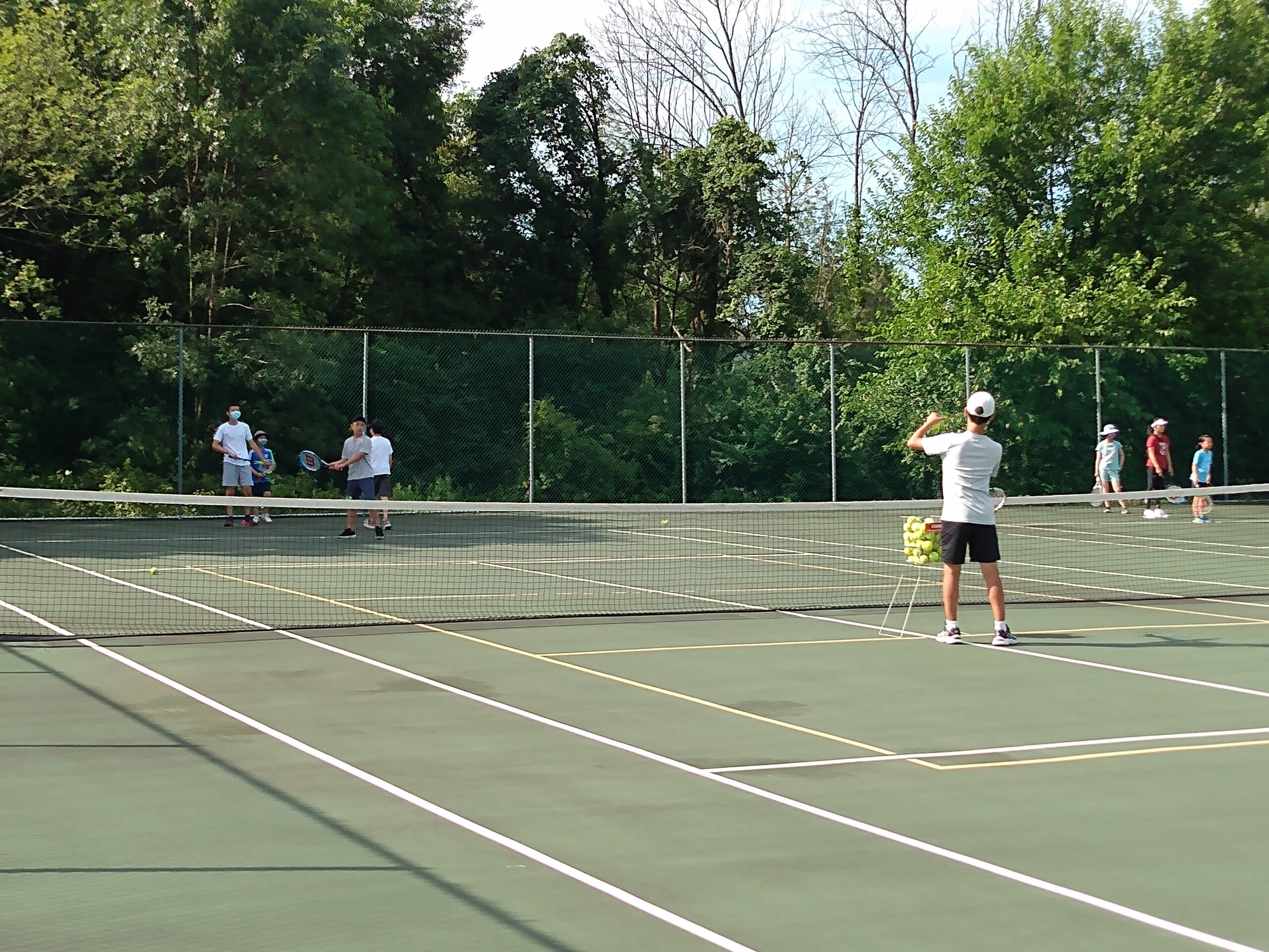 A player practicing a forehand during a ball-feeding drill