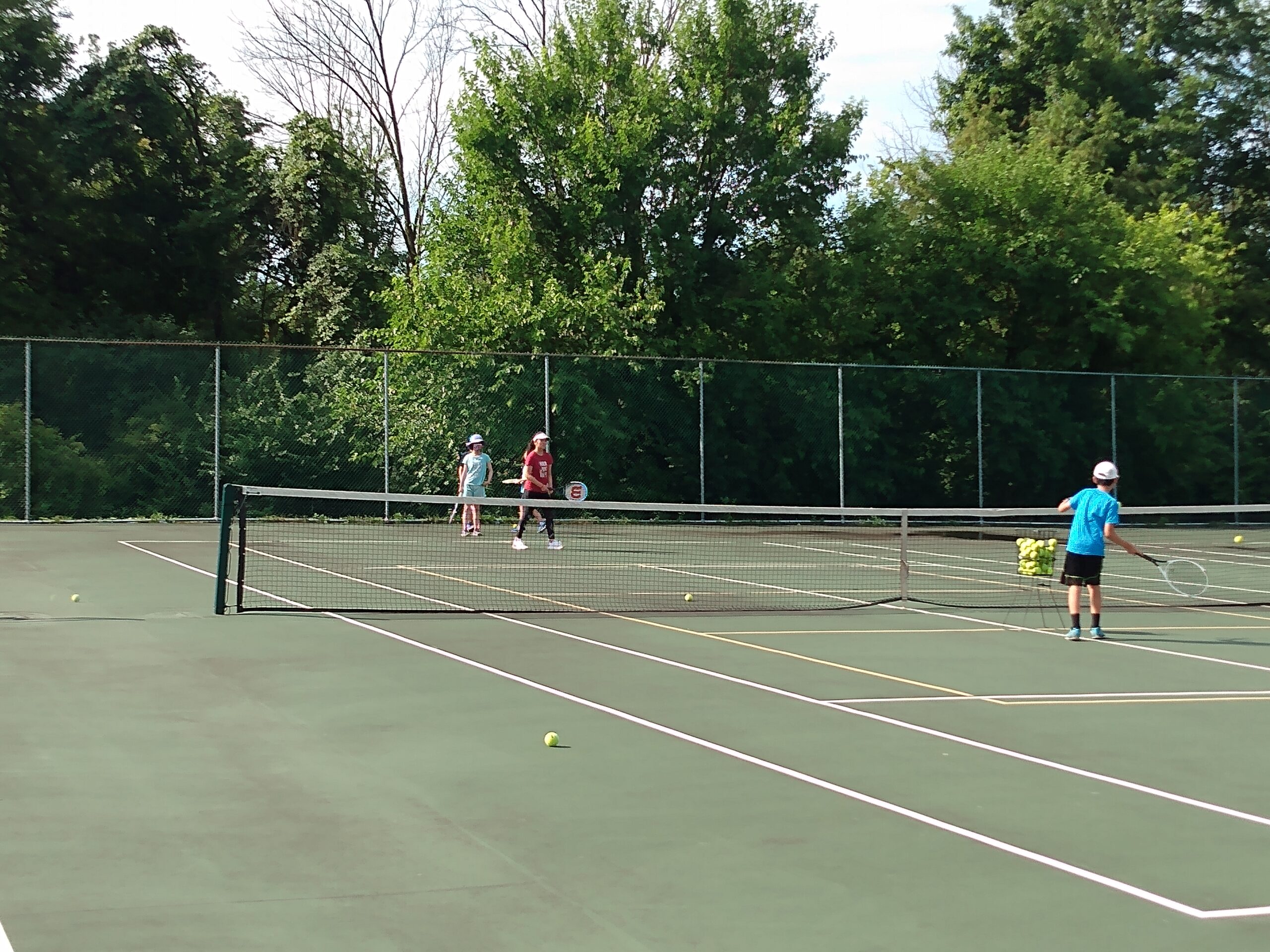 Summer camp players taking turns during a feeding drill