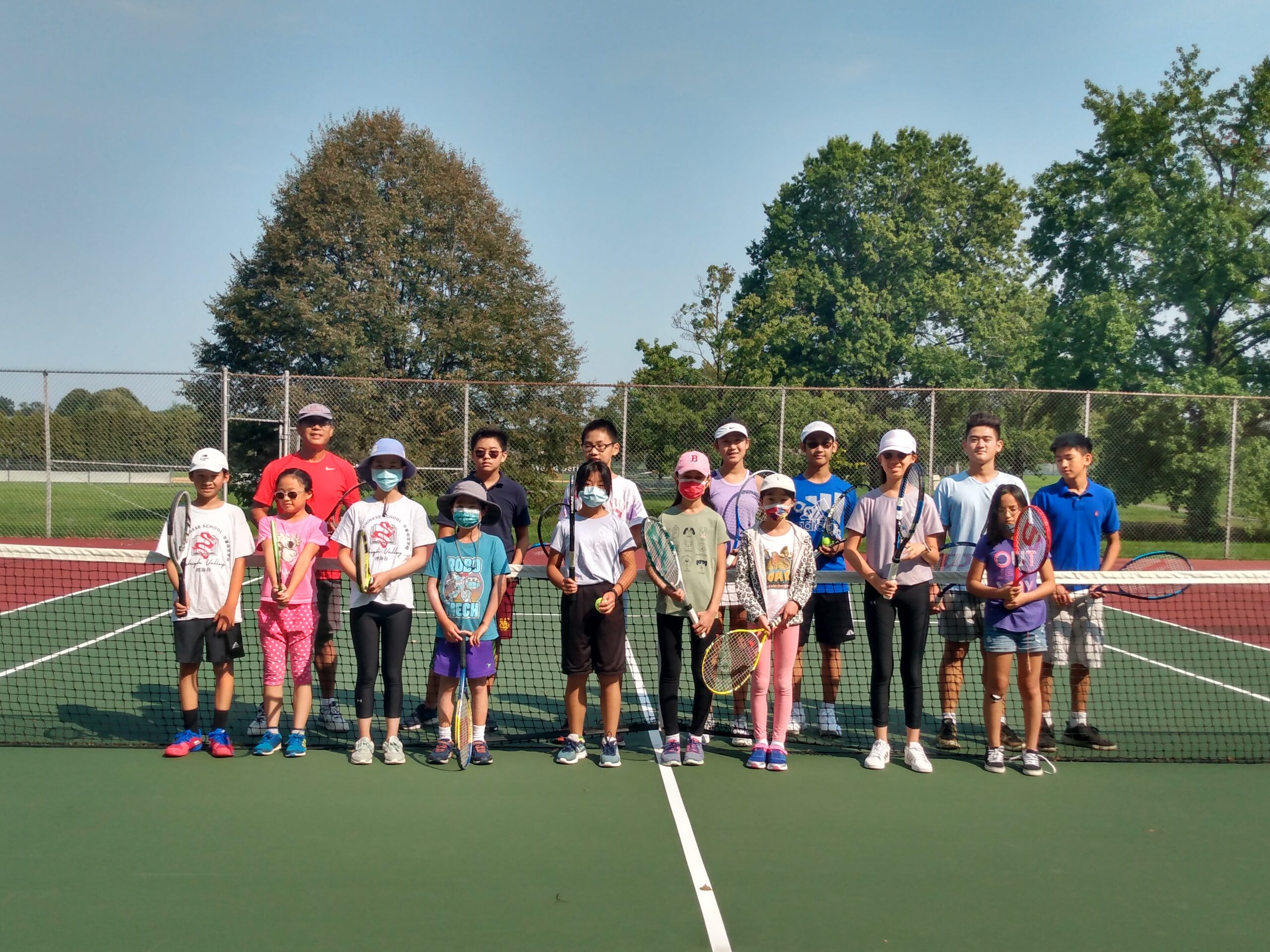 The Fall 2021 tennis club group gathered at the net